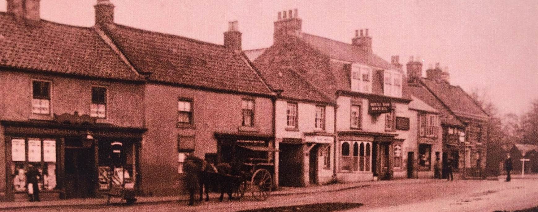A vintage photo of an old building
Description automatically generated